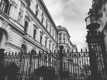 Low angle view of building against cloudy sky