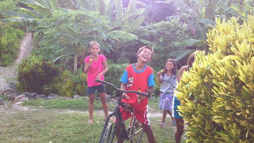Rear view of women standing against plants