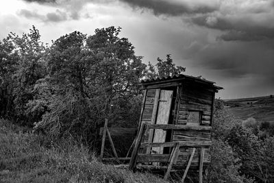 Abandoned built structure on land against sky