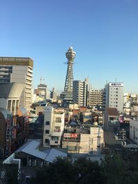 Buildings in city against blue sky