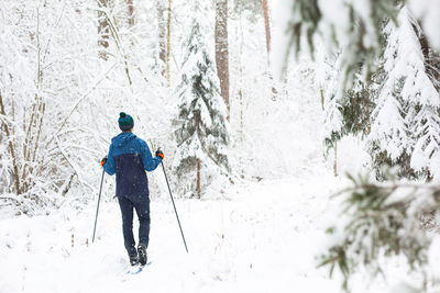 Rear view of man on snow covered land