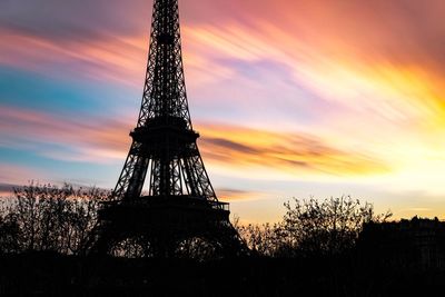 Low angle view of tower against cloudy sky