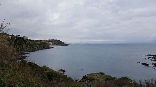 Scenic view of sea against cloudy sky