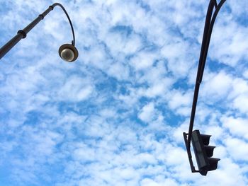 Low angle view of street light against cloudy sky
