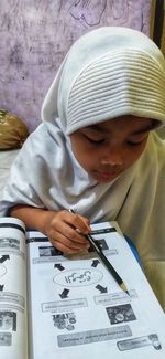 Low section of a girl holding book