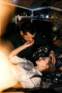 Merry christmas. young couple in love celebrating christmas or new year eve at home. romantic