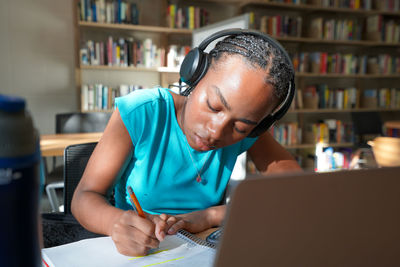 Young woman using laptop at table