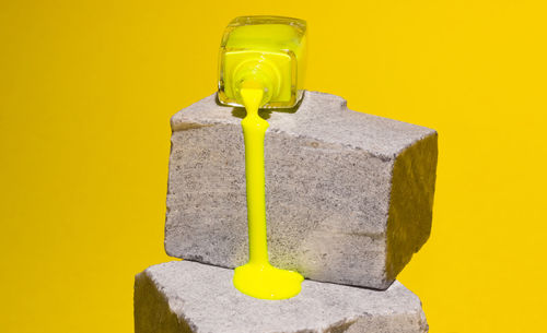 Close-up of lamp on yellow wall