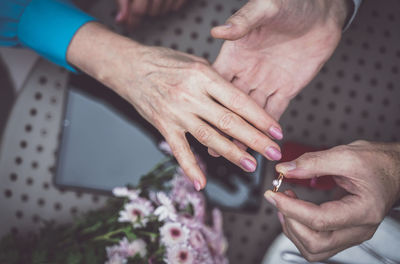 Directly above view of man exchanging ring at table