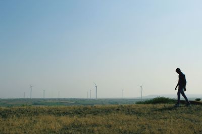 Man standing on field against clear sky