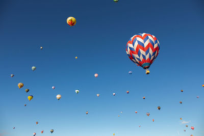 Low angle view of hot air balloons flying in sky