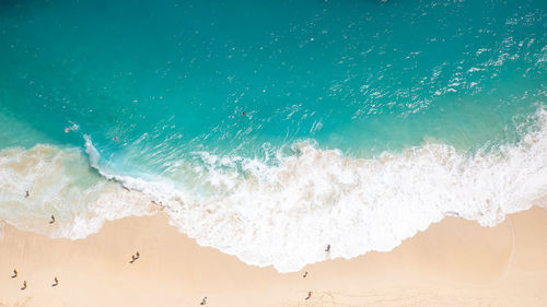 High angle view of waves rushing towards shore