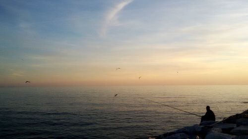 Scenic view of sea against sky during sunset