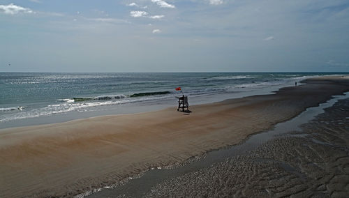 Man standing on beach against sky