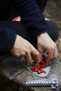 Man's hands cutting pepper outdoors