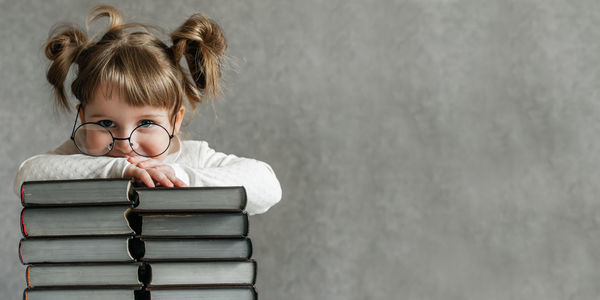 Portrait of boy on book at home