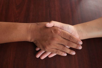 Close-up of hands on table