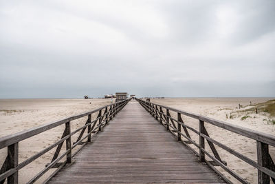 Pier over sea against sky