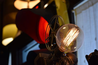 Close-up of illuminated light bulb at home