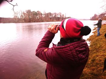 Rear view of woman looking at lake