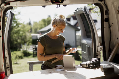 Smiling woman using tools