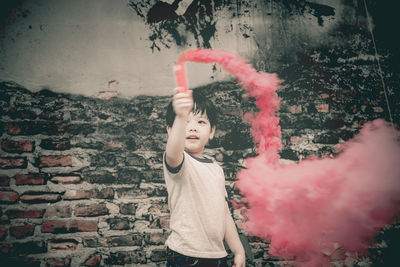 Boy holding smoke bomb