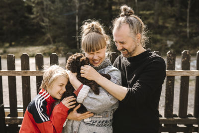 Parents standing with daughter