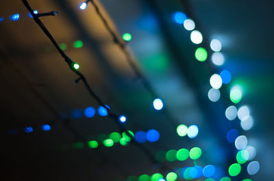 Low angle view of illuminated defocused lights