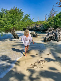 Full length of woman on shore against sky