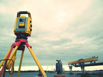 Low angle view of crane against sky