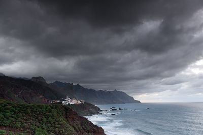 Coastal feature against cloudy sky