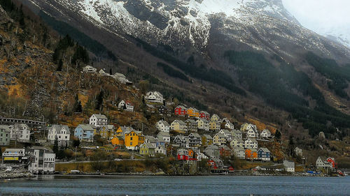 Scenic view of sea by buildings in city