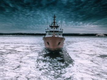 Ship in sea against sky during winter