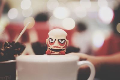 Close-up of tea cup and toy