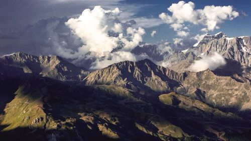 Scenic view of mountain against cloudy sky