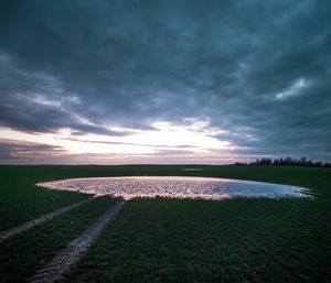 Scenic view of field against sky during sunset