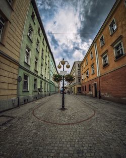 Man walking on street against sky