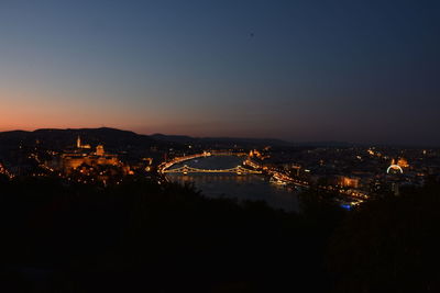 High angle view of illuminated buildings against sky at night