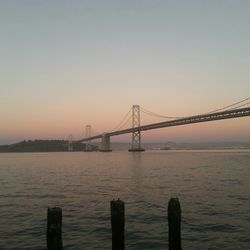 Bridge over river at sunset