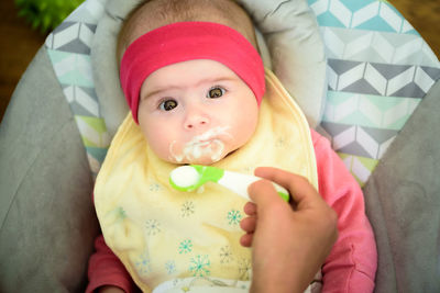 Close-up of hand feeding baby