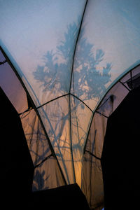Close-up of wind turbine against sky during sunset