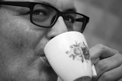 Close-up portrait of man drinking coffee outdoors