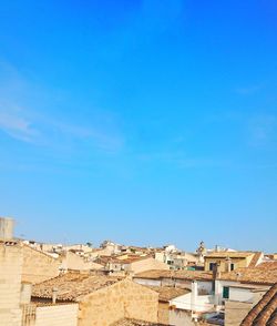 Low angle view of buildings against blue sky