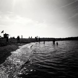 Silhouette of people in water