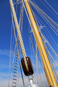 Low angle view of sailboat against clear blue sky