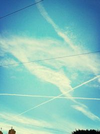 Low angle view of power lines against blue sky