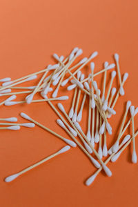 Close-up of cotton swabs on colored background