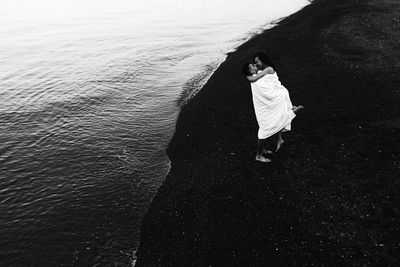 High angle view of woman standing on beach