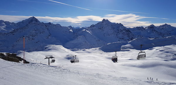 Scenic view of snow covered mountains against sky