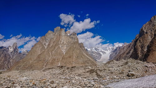 Scenic view of snowcapped mountains against blue sky